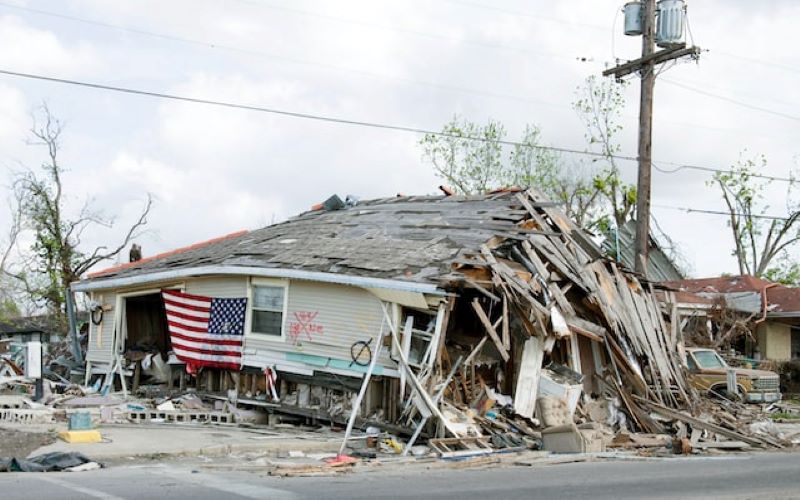 Katrina - Hurricane force winds devasated home beyond repair. American Flag hung on outside of delapotated remains in advance of demolition.