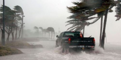 Volunteer search and rescuer driving pickup on Key West beach during Hurricane Force Winds.