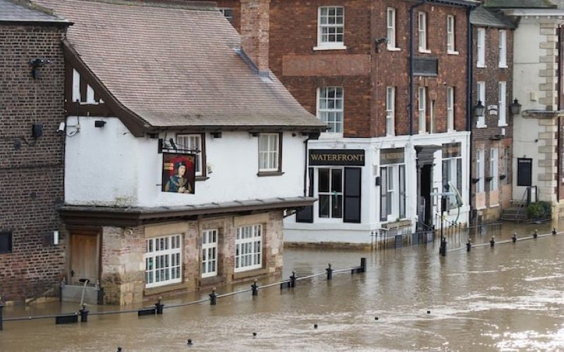 United Kingdom mass flooding. Waist high flooding in the street outside of local pub.